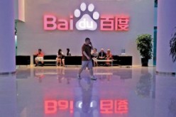 A visitor walks past the lobby of Baidu headquarters in Beijing. 