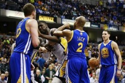 Indiana Pacers center Roy Hibbert (2nd L) shoves Golden State Warriors forward David Lee (L) while Warriors guards Jarrett Jack (2) and Klay Thompson (R) stand near the play during their NBA basketball game in Indianapolis, Indiana February 26, 2013.