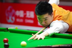China's Ding Junhui steadies his snooker cue during the Nongfu Spring World Cup in Wuxi, Jiangsu Province, on Wednesday, June 17, 2015. 
