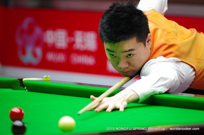 China's Ding Junhui steadies his snooker cue during the Nongfu Spring World Cup in Wuxi, Jiangsu Province, on Wednesday, June 17, 2015. 