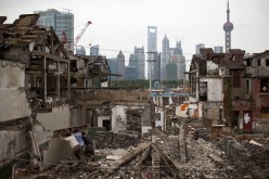 Migrant Chinese laborers work at a demolished residential area in Shanghai. 