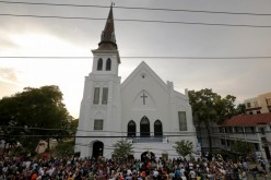 A crowd gathers outside the Emanuel African Methodist Episcopal Church following a prayer vigil nearby in Charleston, South Carolina, June 19, 2015. 