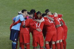 The Peruvian squad huddles before the game against Bolivia.