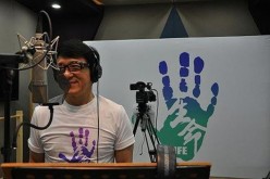 Jackie Chan having fun as he records the song 