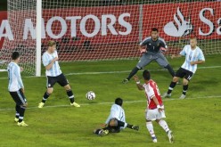 Paraguay's Lucas Barrios (#8) scores against Argentina during their elimination round meeting.