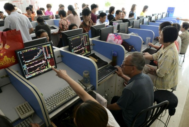 Investors looking at stocks information in Anhui Province, China.