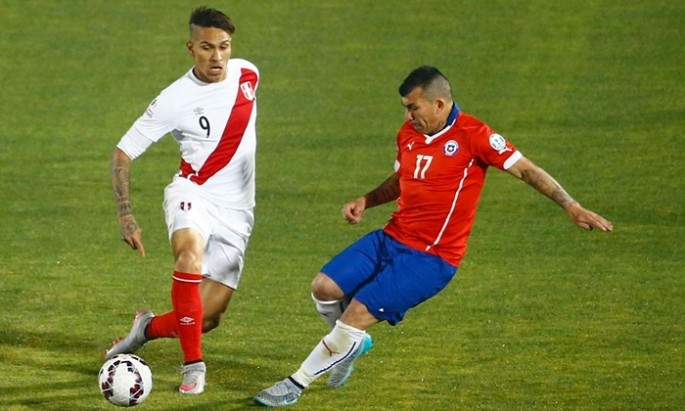 Peru’s Paolo Guerrero (left) tries to evade Chile’s Gary Medel