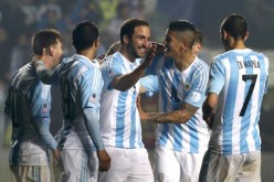 Argentina's Gonzalo Higuain (#9) celebrates with teammates after scoring a goal against Paraguay