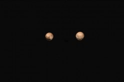 New color images from NASA’s New Horizons spacecraft show two very different faces of the mysterious dwarf planet, one with a series of intriguing spots along the equator that are evenly spaced.