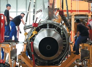 Employees work on an Airbus SAS A320 airplane at the company's plant in Tianjin. 
