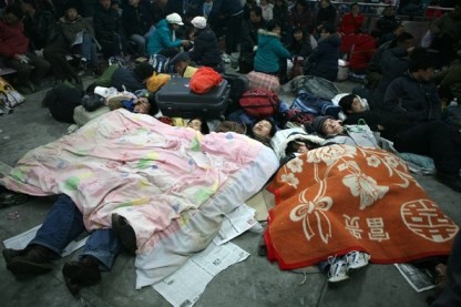 Passengers stranded due to heavy snow rest in the underground garage at the Shanghai Railway Station, Feb. 2008.