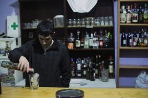 A young man prepares a cocktail at a "Lonja" in Guernica April 20, 2012