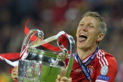 Bastian Schweinsteiger of Bayern Munich holds the German Championship winner’s trophy 