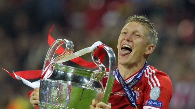 Bastian Schweinsteiger of Bayern Munich holds the German Championship winner’s trophy 