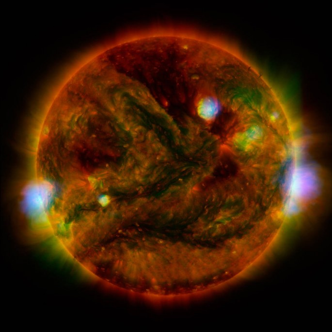 Flaring, active regions of our sun are highlighted in this new image combining observations from several telescopes. High-energy X-rays from NASA's Nuclear Spectroscopic Telescope Array (NuSTAR) are shown in blue; low-energy X-rays from Japan's Hinode spa