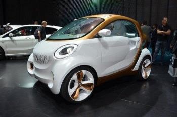 People look at a smart car on display in Guangzhou Auto Show. 