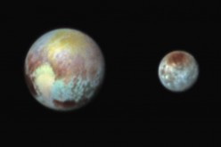 This July 13, 2015, image of Pluto and Charon is presented in false colors to make differences in surface material and features easy to see