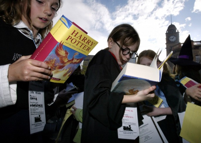 Young ladies browse "Harry Potter" books by J. K. Rowling; "Fantastic Beasts and Where to Find Them" refers to the textbook from Hogwarts School  that appeared in the British novelist's original books and films.