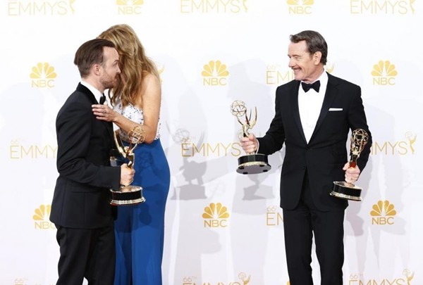 The 66th Primetime Emmy Awards winners Aaron Paul, Anna Gunn and Bryan Cranston pose backstage with their awards for their roles in AMC's "Breaking Bad." 