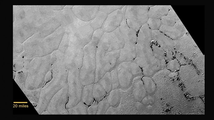 In the center left of Pluto’s vast heart-shaped feature – informally named “Tombaugh Regio” - lies a vast, craterless plain that appears to be no more than 100 million years old, and is possibly still being shaped by geologic processes.