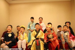 A group photo of children in traditional Chinese garment during a children's traditional cultural fashion show in Wuhan, the capital city of central China's Hubei Province, on July 17, 2015. 