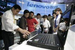 Visitors check a Lenovo computer at the 9th China Beijing International High-Tech Expo held in Beijing in May 2006.