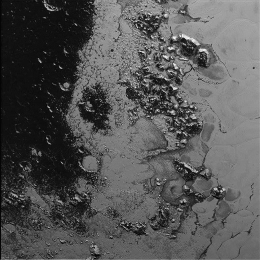 A newly discovered mountain range lies near the southwestern margin of Pluto’s heart-shaped Tombaugh Regio (Tombaugh Region), situated between bright, icy plains and dark, heavily-cratered terrain. 