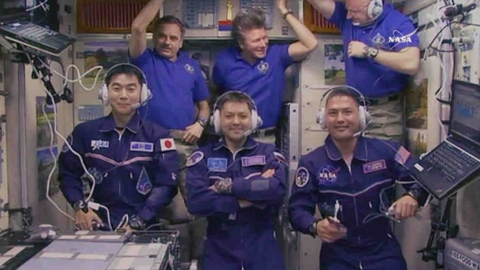 All six Expedition 44 crew members gathered inside the Zvezda service module for a crew greeting ceremony with new crewmates (front row from left) Kimiya Yui, Oleg Kononenko and Kjell Lindgren. In the back from left are Mikhail Kornienko, Gennady Padalka 