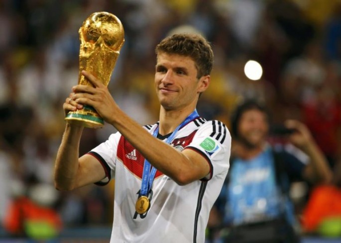Bayern Munich and Germany national team's Thomas Müller lifting the 2014 World Cup.