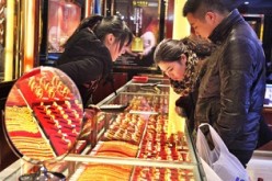 Customers buy gold jewelry in a shop in Ganyu County, Jiangsu Province.