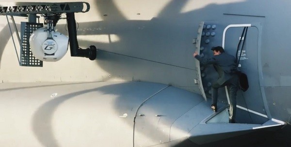 Tom Cruise gives the OK sign as he begins shooting a jaw-dropping scene where he gets to cling on a moving aircraft.