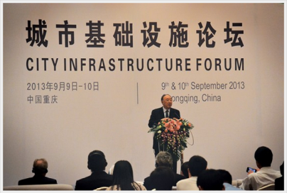 Huang Qifan, mayor of Chongqing, speaks before delegates of city infrastructure forum in 2013.