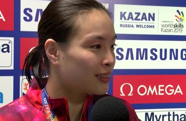 Wu Minxia gets interviewed after her win.
