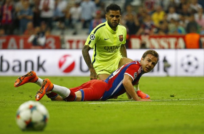 Bayern Munich's Mario Götze (on all fours) with Barca's Dani Alves 