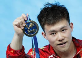 China's rookie diver Xie Siyi shows his medal after winning the men's 1m springboard final at the FINA World Swimming Championships on Monday, July 27, at Kazan, Russia.