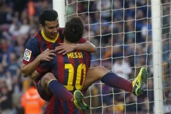 Pedro is carried by Barca teammate Lionel Messi.