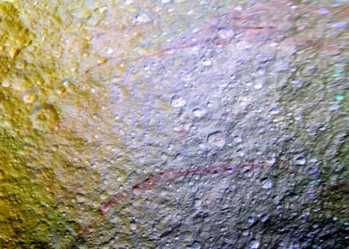 Unusual arc-shaped, reddish streaks cut across the surface of Saturn's ice-rich moon Tethys in this enhanced-color mosaic. The red streaks are among the most unusual color features on Saturn's moons to be revealed by Cassini's cameras.