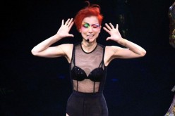 Sammi Cheng in funky makeup and hairdo and a see-through top while performing a part in her latest concert tour. 