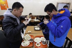 Diners take pictures of the steamed bun meal that President Xi Jinping ate and made famous at the Qingfeng restaurant in Beijing.