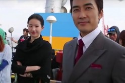 Liu Yifei and Song Seung Heon smile at the camera during a break while filming “The Third Way of Love.”