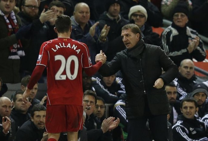 Liverpool's manager Brendan Rodgers (R) shakes hands with his player Adam Lallana.