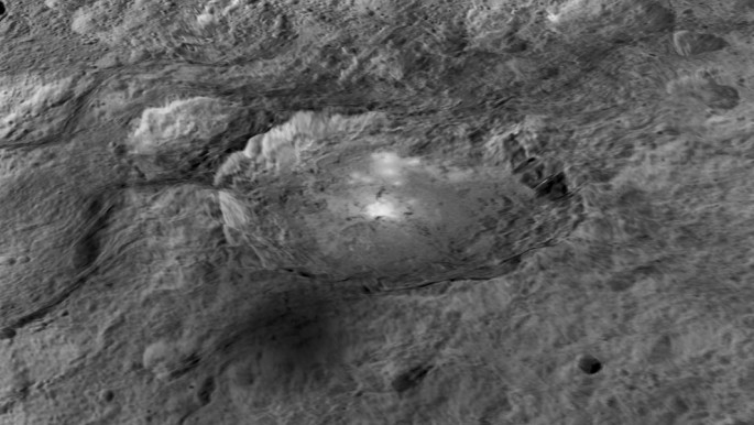 The intriguing brightest spots on Ceres lie in a crater named Occator, which is about 60 miles (90 kilometers) across and 2 miles (4 kilometers) deep.