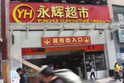 People walk past a Yonghui Superstore outlet.