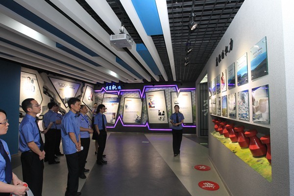 Visitors in an education center in Wenzhou, Zhejiang Province, look at the presentations on the wall.