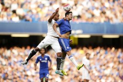 Swansea City's Ashley Williams battles Chelsea's Diego Costa for the ball.