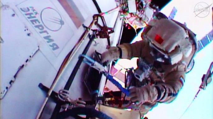Cosmonaut Mikhail Kornienko is seen working outside the International Space Station in a Russian Orlan spacesuit. 