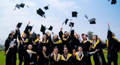 Graduates of Renmin University celebrate during their graduation, part of the hordes of new graduates that compete for jobs every year.