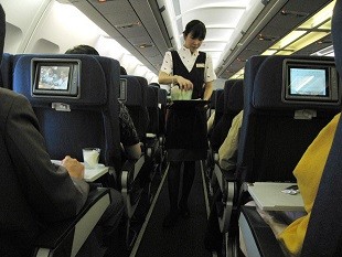 An attendant of a Chinese airline serves passengers in a flight. According to reports, cases of bad behavior against airline staff have increased recently.