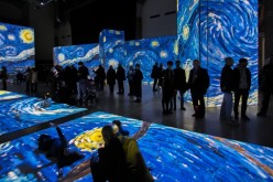 Visitors at the exhibit “Van Gogh Alive – The Experience” examine the artist's famous 