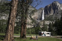 A family has a picnic in view of Upper Yosemite Falls in Yosemite National Park, California.